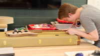 Gryphon Mawhorter working on a guitar