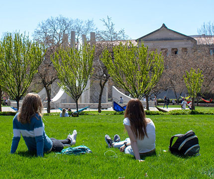 students hanging out an in hammocks by engineering fountain