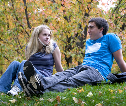 students sitting together in autumn