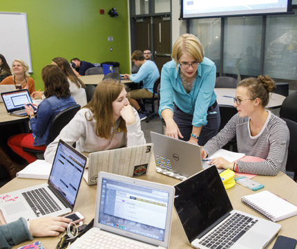 teacher helping students