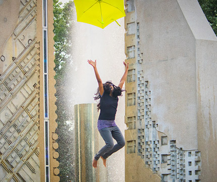 purdue student jumping with arms raised 